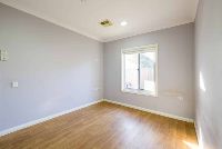 A bedroom with natural sunlight coming through from the bedroom window