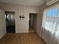 bedroom view to shared bathroom and hallway