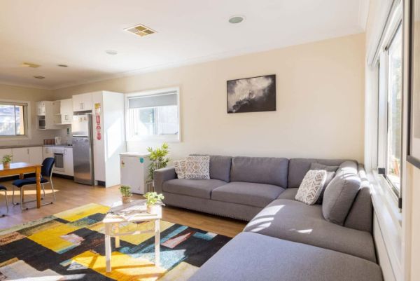 Shot of-the-living-room-with-view-of-the-kitchen-and-window-outside